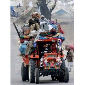 Pakistan Earthquake Survivor Family Ride a Vehicle as They Make 