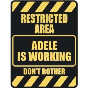   RESTRICTED AREA ADELE IS WORKING  PARKING SIGN