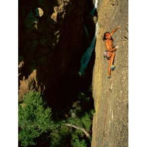  A Rock Climber Scales the Vertical Face of a Mountain 